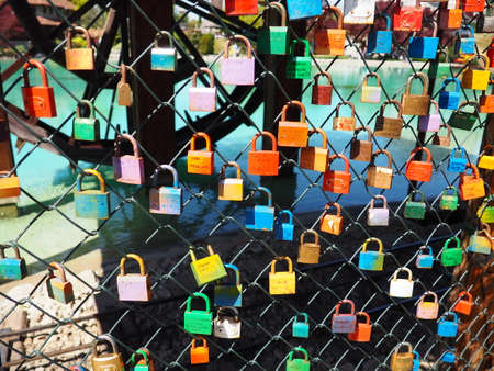 Stanisici, Bijelina, Bosnia and Herzegovina. April 25, 2021 Locks of love on a metal mesh. Many colorful beautiful castles were left by young wives and lovers. Locks hang from the fence.のeditorial素材