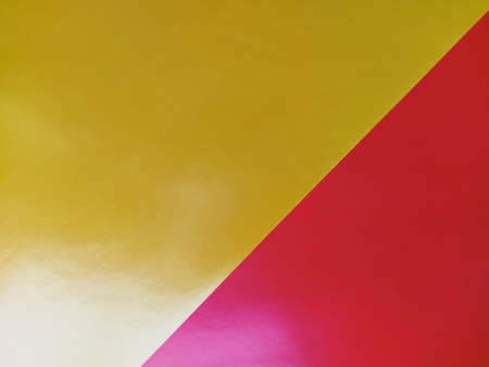 Yellow-pink bright background. Diagonally laid sheets of colored paper with a gradient and light flare.の写真素材