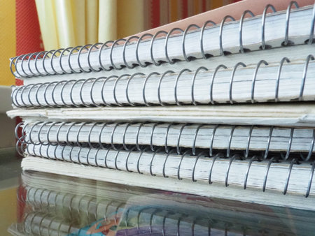 A stack of spring notebooks. Thick notebooks or notebooks placed on top of each other. Office items...