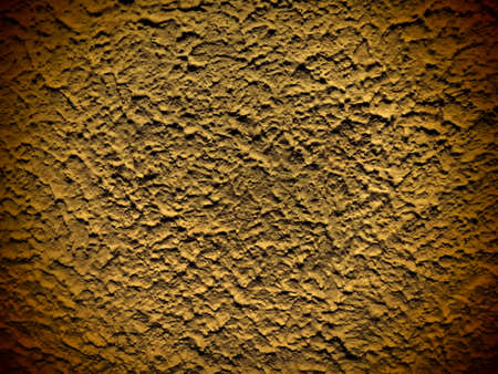 Plaster with pimples, finishing layer formed by hardened building cement mortar. Hand-plastered walls.a with the effect of waves, elevations and irregularities. Yellow background with brown vignetteの写真素材
