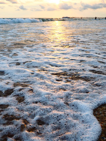 Sunset over sea. Beautiful sunset. Foamy waves roll over the sandy shore. Vityazevo, Anapa, Black...