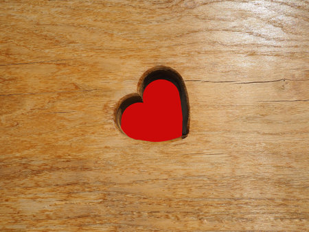 Heart carved in wooden wall texture. Postcard or blank for Valentines Day on September 14th. The...