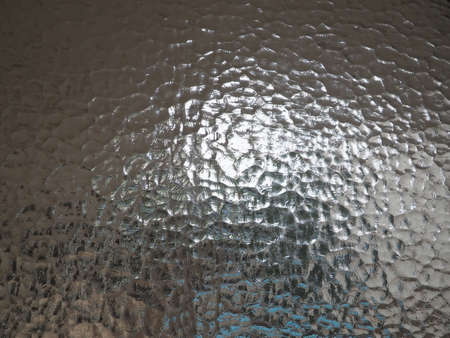 corrugated glass with a light and dark background. reflections of light. Close up and copy spaceの写真素材