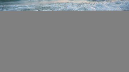 Buoys on a rope near sea water. The buoys are pink restraints to alert people to the depth of the...