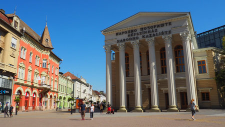 Subotica, Serbia 12 September 2021 People walk around the square in the tourist center of Subotica. The building of the National Theater and library, shops and pharmacies. Good summer weather.のeditorial素材