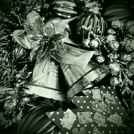Christmas background with Christmas decorations, holiday balls, bells, bows, dots, fir cone, Christmas tinsel. Happy New Year and Merry Christmas. Black and white monochrome photo with green filterの写真素材