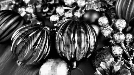 Christmas background with Christmas decorations, holiday balls, bells, bows, Christmas tinsel. Happy New Year and Merry Christmas. Black and white monochrome photo. Retro vintage style.の写真素材
