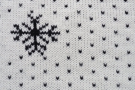 Jacquard knitted pattern. Geometric ornament for Christmas or New Year. Knitted black snowflakes and...