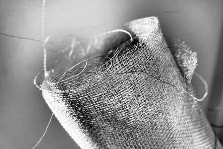 Metal mesh. Rolled mesh in gray. Heavy duty steel or aluminum mesh with ragged edgesの写真素材