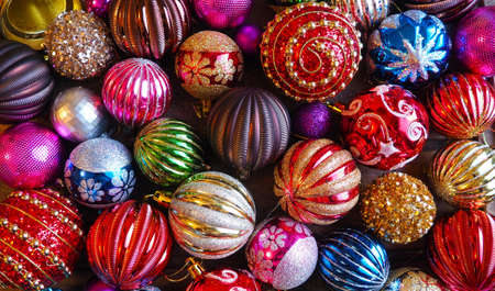 Christmas decorations. Beautiful red, golden, yellow balls with sparkles and stripes. Preparing for the New Year and Christmas holidays. Beautiful decorations. Flat lay and still life. Modern styleの写真素材