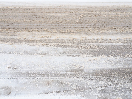 Snowdrifts on the side of the road. Bad weather and traffic. Snow on asphalt. Difficult driving...