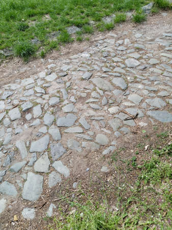 Paving stones - a hard road surface, a kind of pavement, lined with flat rectangular bars of the same shape and size. Block stone from which the road surface was built. Petrovaradin, Novi Sad, Serbia.の写真素材
