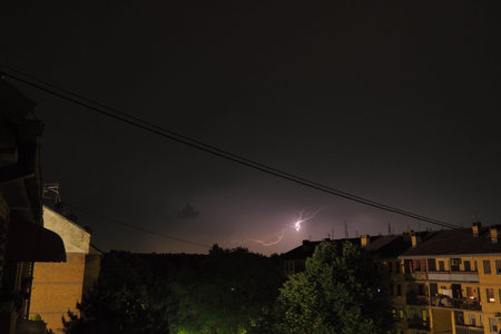 Thunderstorm at night over the city. Flashes of lightning and low clouds. Thunder and lightning....