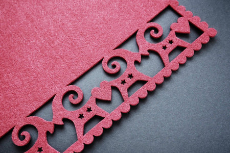 Background New Year's or for Valentine's Day. Kissing goats with stars and hearts are carved on red...