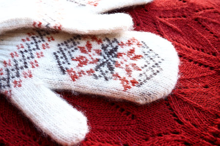 Fluffy white knitted mohair mittens with a traditional floral pattern on the back. A pair of mittens...