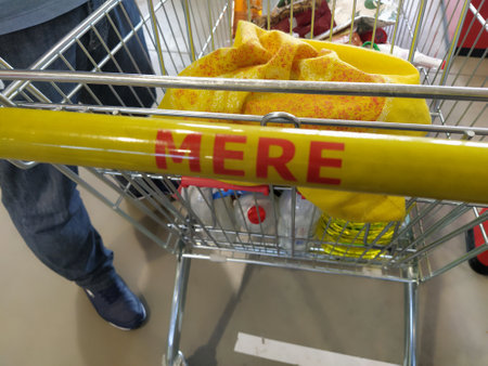 Shopping cart, MERE discounter chain stores, Ruma, Serbia, April 15, 2022 supermarket with logo and brand MERE. Food and household goods at cheap prices. Shopping cart handle. Goods in cartのeditorial素材