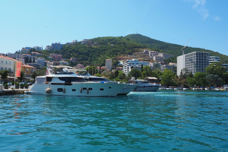Budva, Montenegro, August 15 2022 Adriatic sea, coast, mountains, sea ripples. Boats and ships are moored to the embankment. Water transport parking. Summer resort trips with water activities. Tourismのeditorial素材
