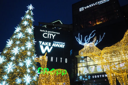 Moscow, Russia, January 17 2023 Street Christmas tree with snowflakes and festive balls. Metro Yugo-Zapadnaya. Christmas decorations in front of the mall. Silver stars, snowflakes and golden deersのeditorial素材