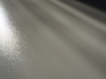 Diagonal rays of light on a gray background. Blurred abstract background light effect, light leaks....