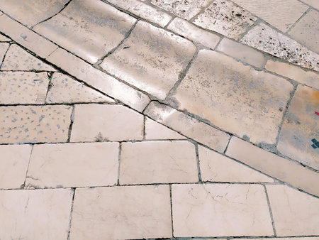 Marble floor on the street, Dubrovnik, Croatia. Antique masonry tiles rectangular blocks. Metamorphic rock composed of calcite CaCO3. Drainage, charcoal for water flow, drain channel. Polished tilesの写真素材