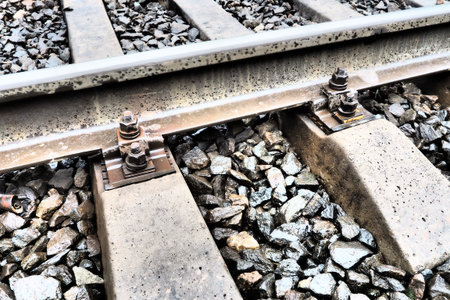 Railways. Metal steel rails and wooden sleepers. Rivets and fasteners on the railroad. Stony...
