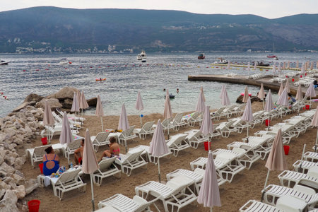 Herceg Novi Montenegro 08.09.2022 Sea vacation trip. Boats float on Adriatic Sea. Mediterranean travel. People swim, sunbathe and have fun on the city beach. Happy people rest on the Adriatic coast.のeditorial素材