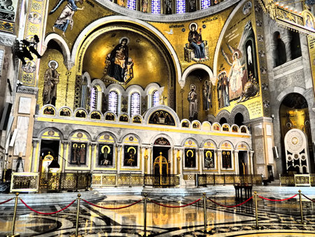 Belgrade, Serbia, 9.9.23 Interior and religious decoration of the Church of St. Sava. Painted designs, icons, gold details, columns and domes. Wheel chandelier horos. Sava Cathedral, curved sculpturesのeditorial素材