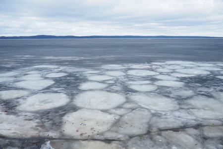 Ice drift in spring on Lake Onega, Karelia. Dangerous thin spring ice in April. Aggregate...