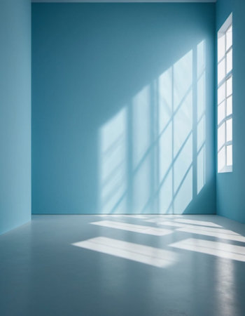 Blue wall and large window. Sunlight is streaming through window, casting long shadows on wall. Room is bright and airy, with clean, minimalist feel. Background for interior or product display.の素材