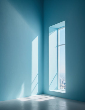 Blue wall and large window. Sunlight is streaming through window, casting long shadows on wall. Room is bright and airy, with clean, minimalist feel. Background for interior or product display.の素材