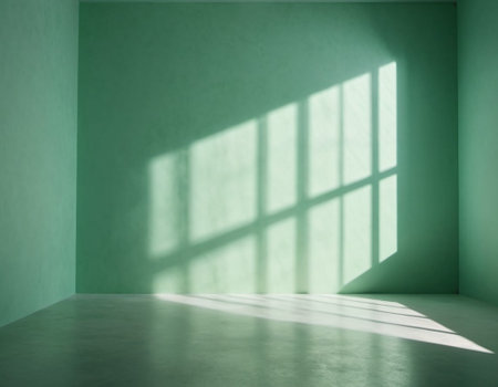 Green wall and large window. Sunlight is streaming through window, casting long shadows on wall. Room is bright and airy, with clean, minimalist feel. Background for interior or product display. AI.の素材