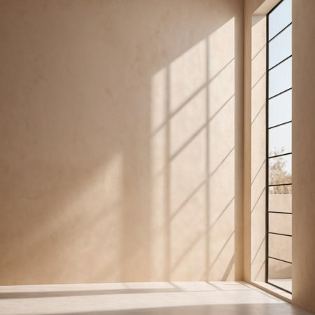 Beige wall and large window. Sunlight is streaming through window, casting long shadows on wall. Room is bright and airy, with clean, minimalist feel. Background for interior or product display.の素材