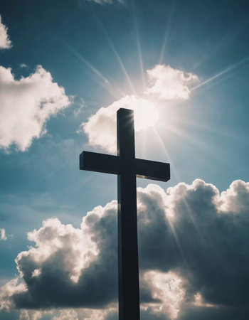 A cross stands prominently as sunlight pierces through thick clouds, creating a radiant display in the sky during the early afternoon. Generative AI.の素材