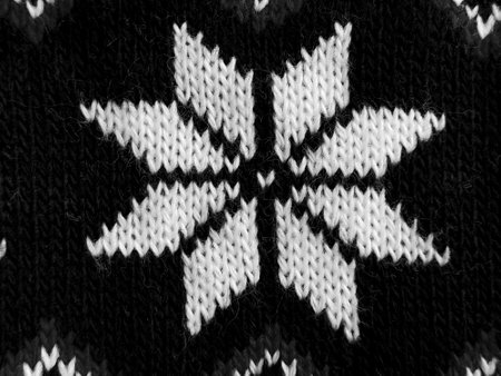 This intricate winter knitting pattern showcases a striking symmetrical snowflake in black and white. Perfect for cozy projects, this design captures the essence of winter craftsmanship and warmth.の写真素材
