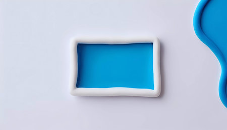 Colorful play dough shapes rest on a vivid blue background, surrounded by a smooth white surface that highlights artistic possibilities and invites creativity.の素材