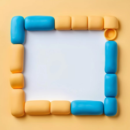 Bright blue and yellow play doh shapes are arranged in a square frame on a soft abstract background. The empty space invites ideas and creative expression.の素材