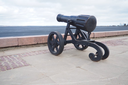 Petrozavodsk, Karelia, Russia, April 18, 2024: embankment of Lake Onega, decorative cast iron cannon looking towards the water. The capital of Karelia was famous for its Alexandrovsky cannon foundryの写真素材