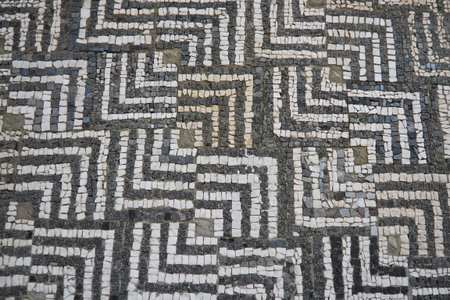 Exploring the rich heritage of Stari Bar, visitors admire detailed mosaic designs in ancient ruins, reflecting history and artistry of old town located in Montenegro. Geometric diamond square patternの写真素材