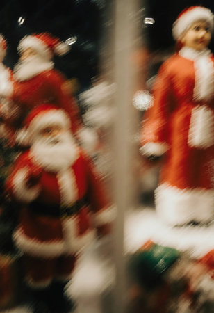 Various Santa Claus figures are showcased in a festive display. The setting is vibrant and colorful, capturing the joy of Christmas and New Year celebrations. Tilt shift effect. Generative AI.の素材
