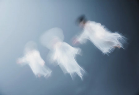 Ethereal figures resembling ghosts float through a hazy space, dressed in flowing white garments. The twilight setting adds to the mysterious and enchanting mood.の素材