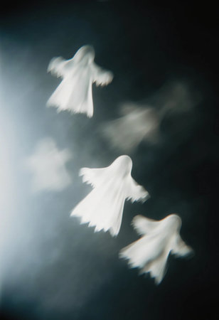 Four translucent ghosts float gracefully in a dimly lit space, their forms softly blending into the shadows, enhancing the haunting atmosphere of the moment.の素材