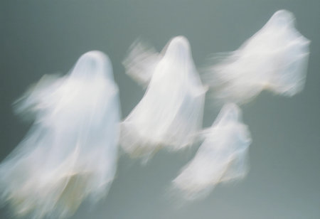 Four translucent ghosts are seen floating in a misty landscape during dusk. Their movements create a sense of eeriness, enhancing the mysterious ambiance of the scene.の素材