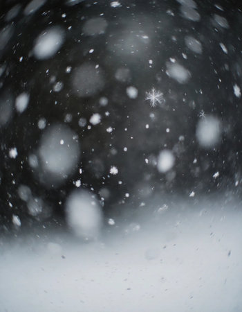 Snow falls steadily, creating a white blanket on the ground. Flakes swirl in the air, showcasing the winter season and its cold atmosphere.の素材