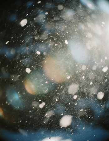 Bright light shines through moving particles in the air, creating a scene filled with visual interest during a sunny day. The light beams mix with the dust and fog.の素材