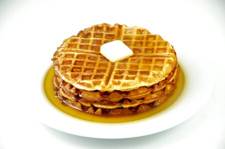 Waffles with maple syrup and butter on a white plate and shot on a white backgroundの写真素材