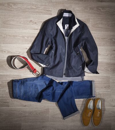 Men shoes, pants, jacket and shirt, accessories, fashionable clothing on the wooden floorの写真素材