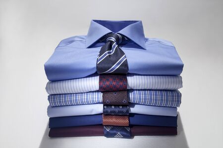 Folded Man's shirts and ties isolated on white background.の写真素材