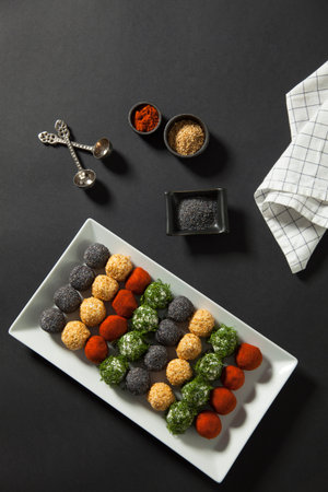 Cheese platter, appetizer. Spicy, sesame, blue poppy, red pepper, parsley cheese balls. With whole...