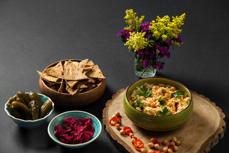 Humus. Halva with tahini and organic chickpeas. Whole wheat lavash chips, pickled cucumbers with red...