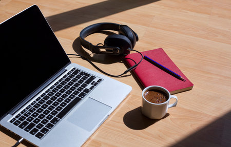 laptop, pen, notebook, glasses and headphones on the table. Study, work desk. Online education. Home...